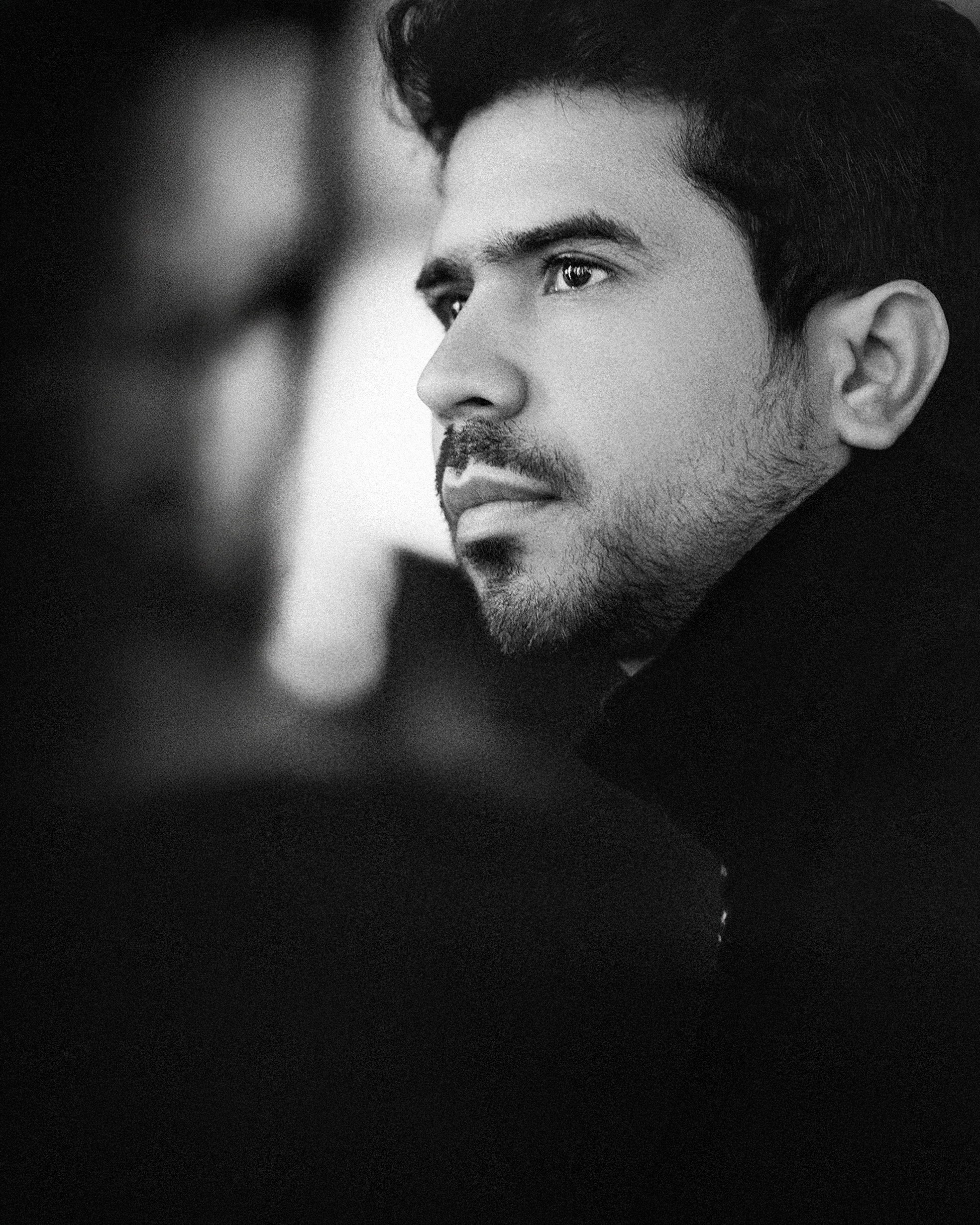 Portrait of the artist holding a camera